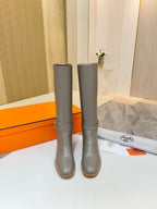 Women’s knee-high gray leather boots with mid-calf shaft and block heel