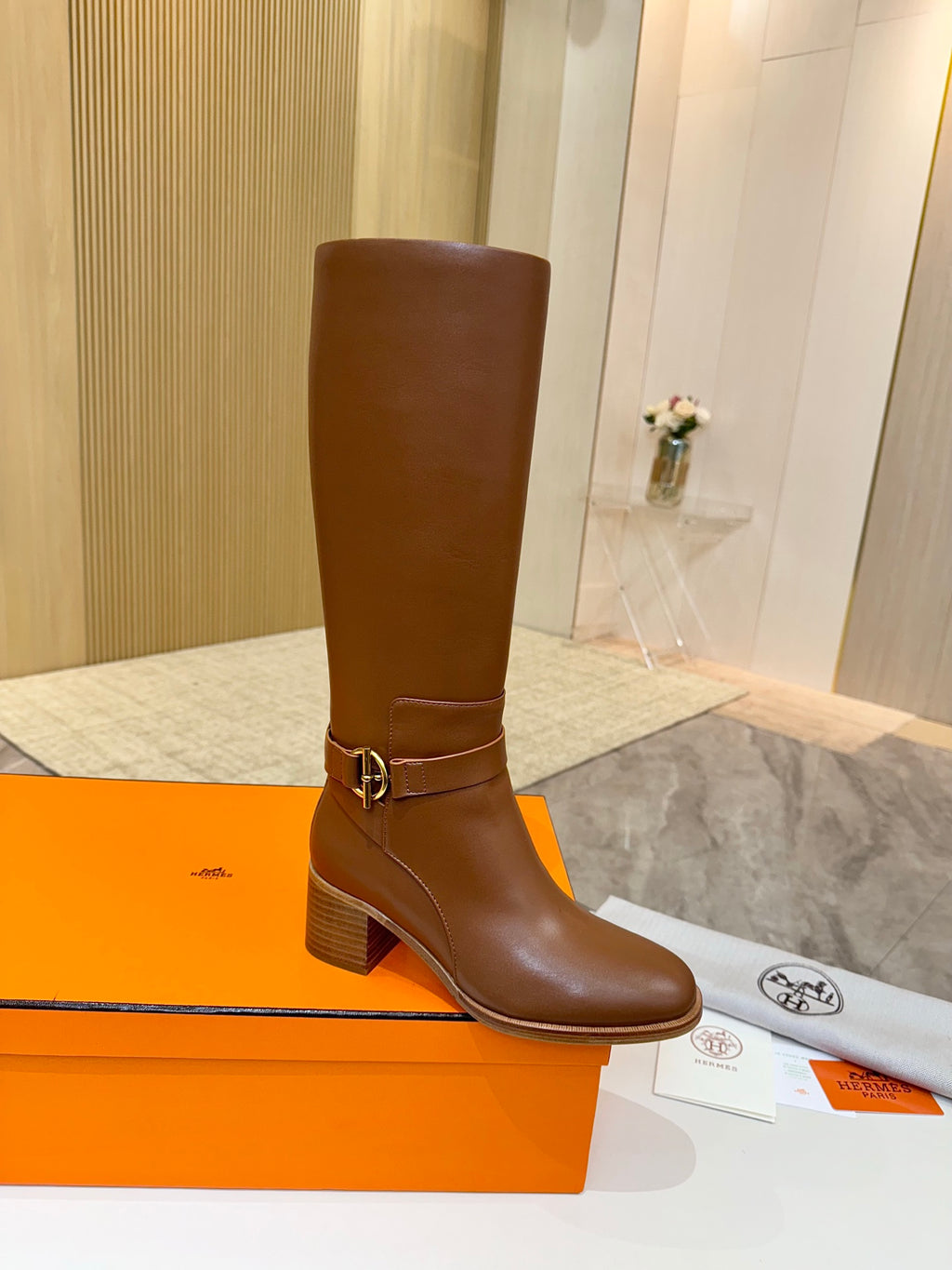 Hermes womens brown knee-high leather boots with gold-tone buckle at ankle and block heel