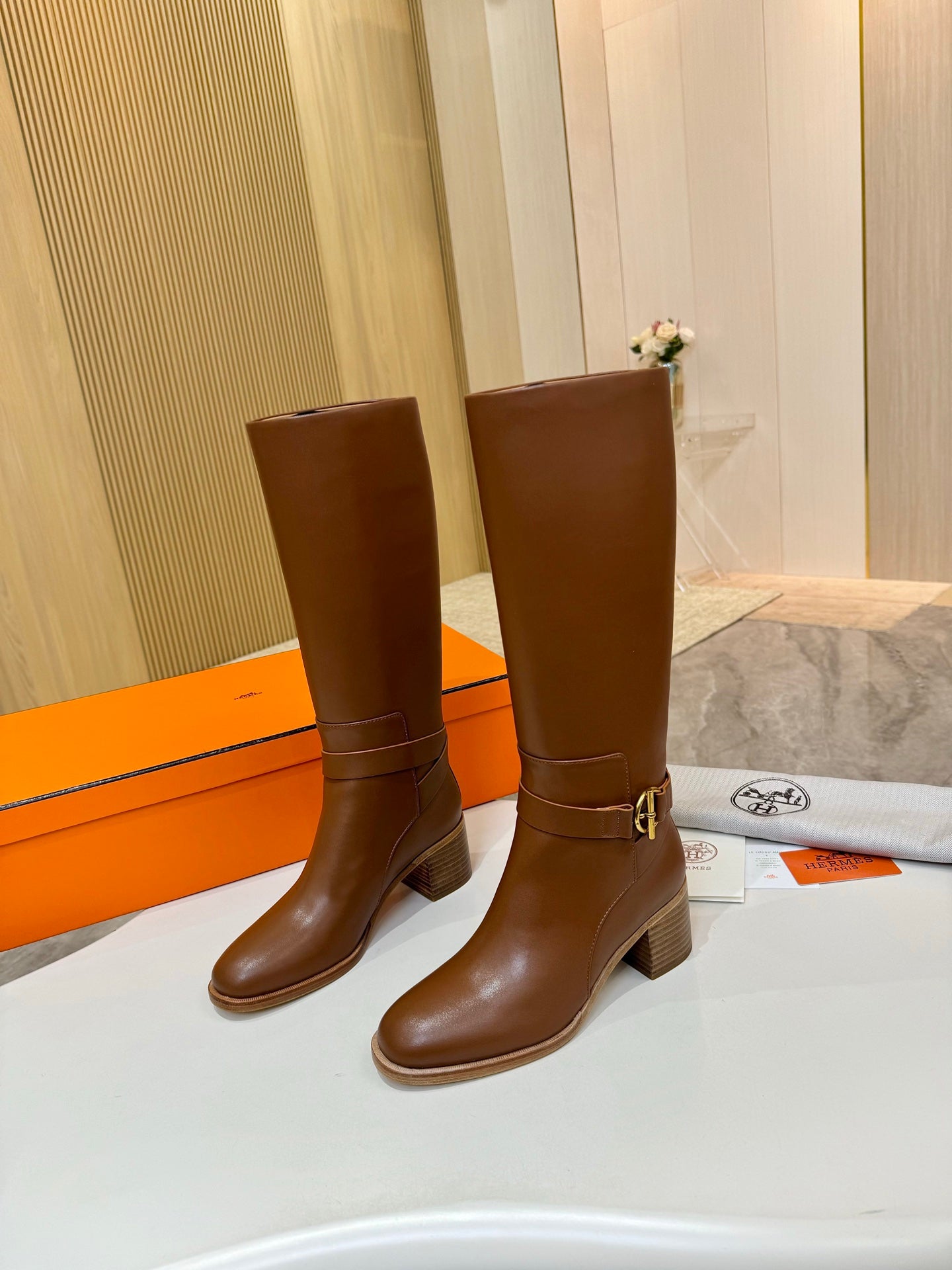 Hermes womens brown knee-high leather boots with ankle buckle strap and block heel