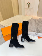 Black suede knee-high boots with gold buckle strap detail and block heel