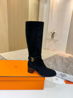 Black suede knee-high boots with gold buckle detail and block heel
