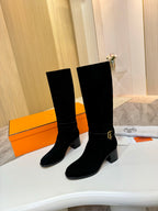 Black suede knee-high boots with gold buckle on cuff and low block heel