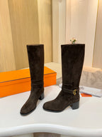 Dark suede knee-high boots with gold-tone buckle at shaft, side angle