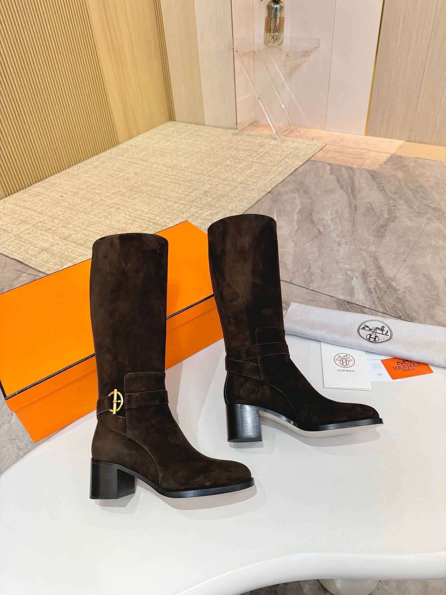 Dark suede knee-high boots, side view, block heel and buckle detail