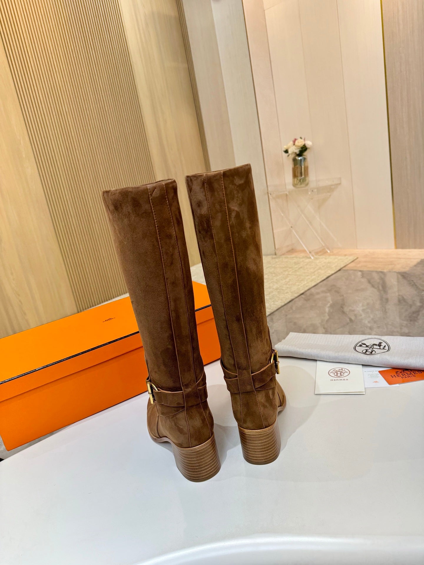 Back view of brown suede mid-calf boots with block heels and stitching