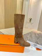 Brown suede mid-calf heeled boots with metal buckle detail at ankle