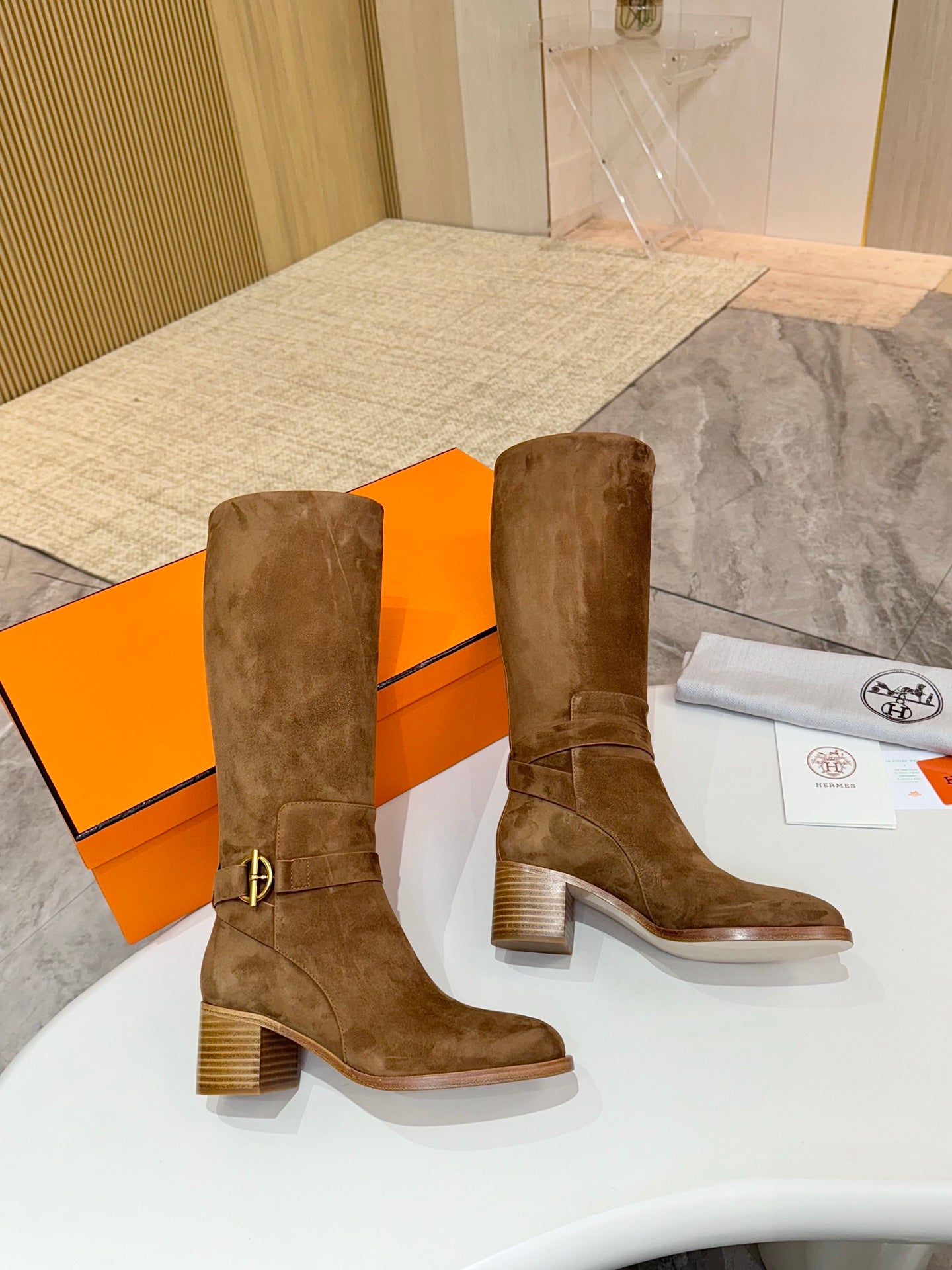 Brown suede mid-calf boots with block heels and ankle buckle