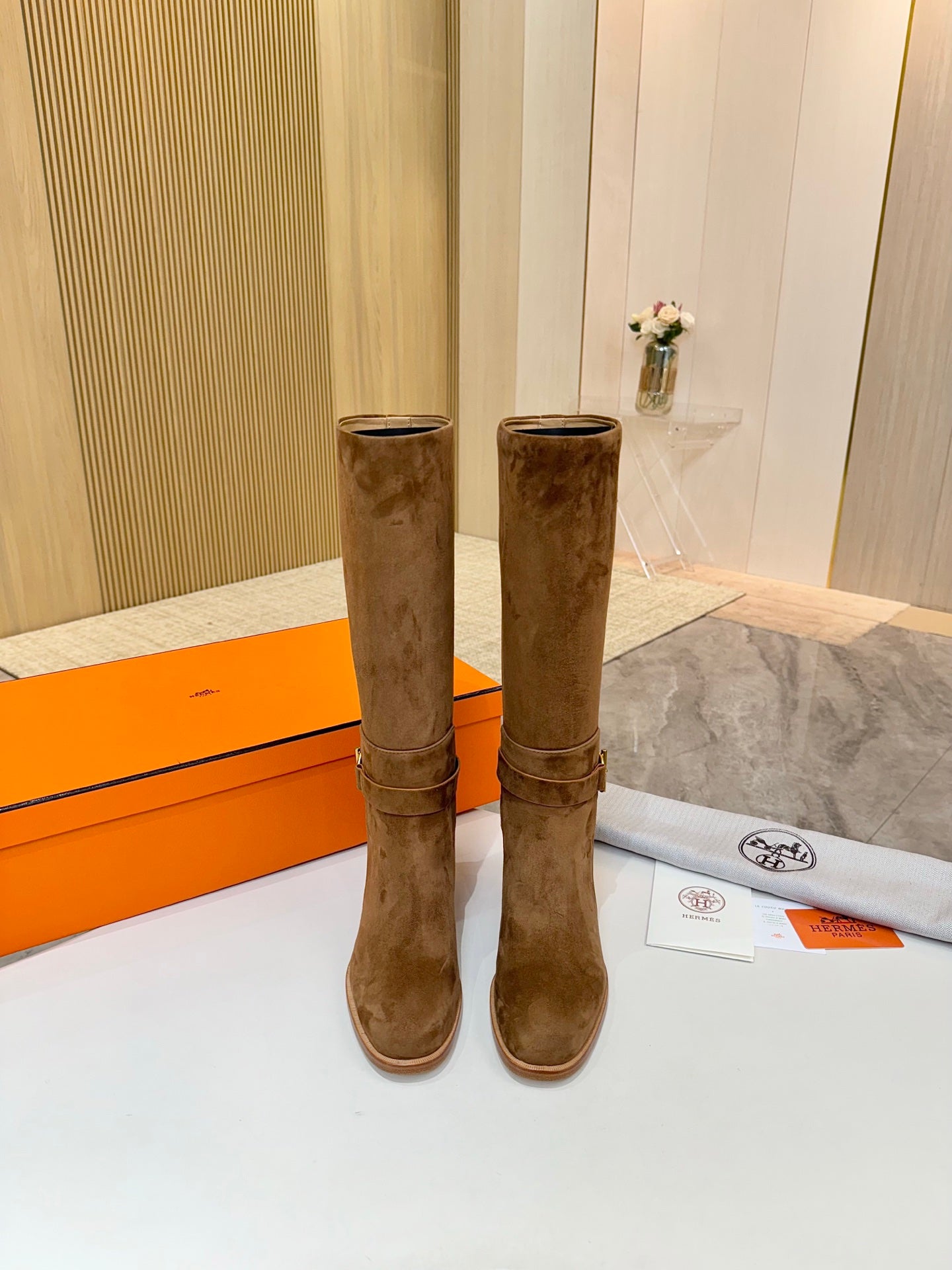 Pair of brown suede mid-calf boots with block heels and ankle buckle