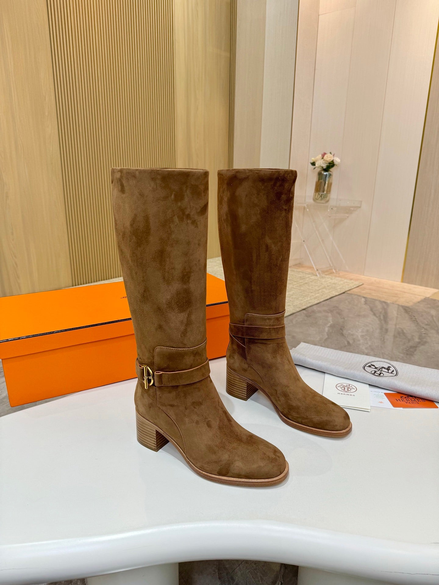 Brown suede mid-calf boots with block heels and gold-tone ankle buckle