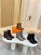 Three pairs of ankle boots with gold buckle: brown, gray, and black