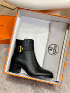 Black leather ankle boot in orange box with gold logo buckle detail