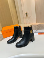 Black leather ankle boots with side buckle logo and mid block heels