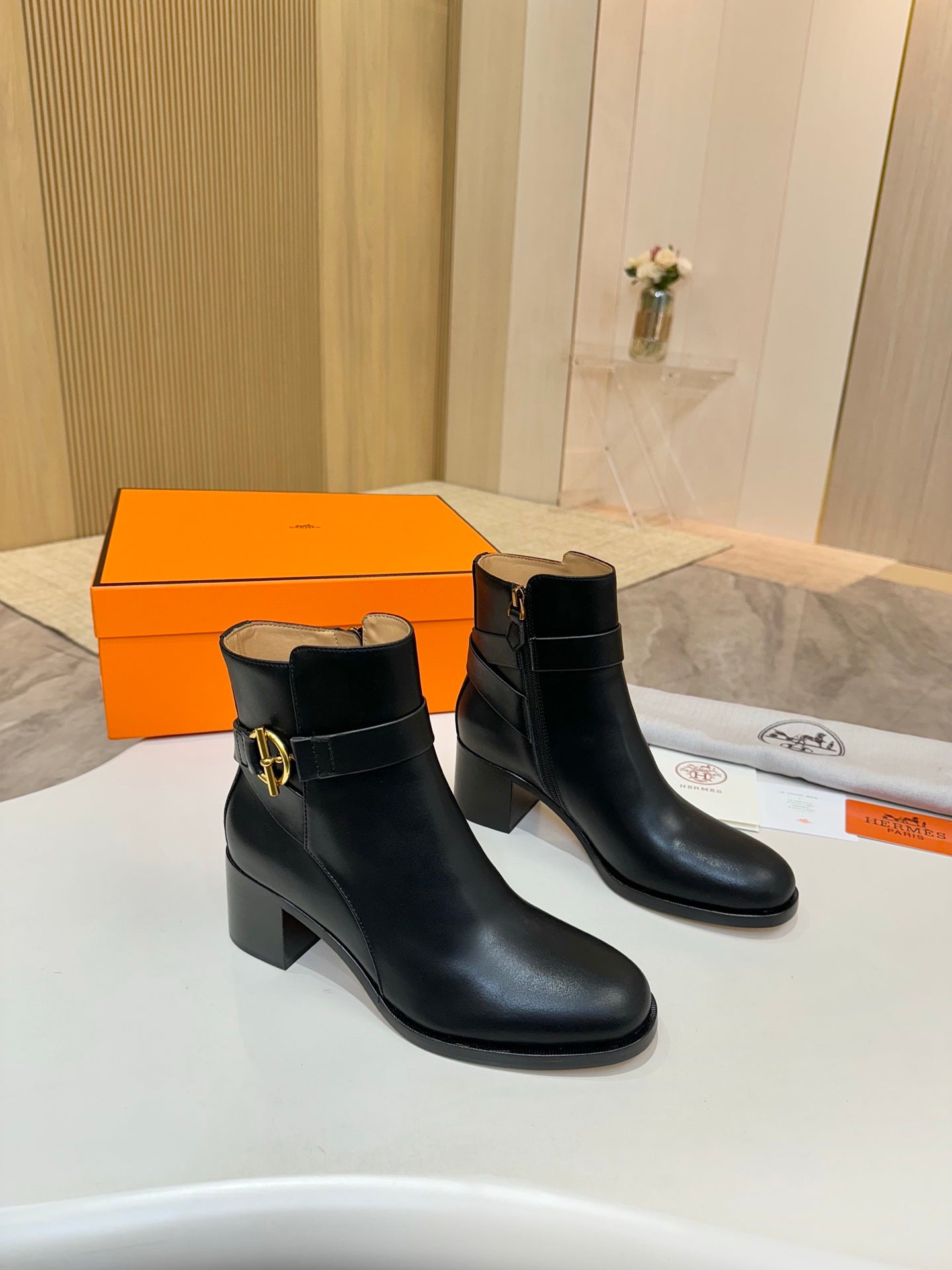 Black leather ankle boots with gold buckle logo, mid block heel