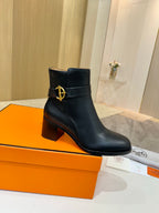 Black leather ankle boots with gold logo detail and stacked block heel