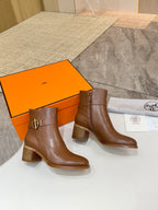 Brown leather ankle boots with block heels and gold buckle strap, side-by-side