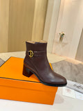 Brown leather heeled ankle boots with gold logo buckle at side