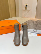 Light gray ankle boots with gold buckle, mid stacked heel