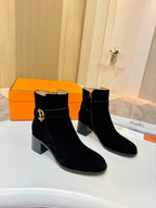 Black suede ankle boots with gold logo buckle and chunky block heel