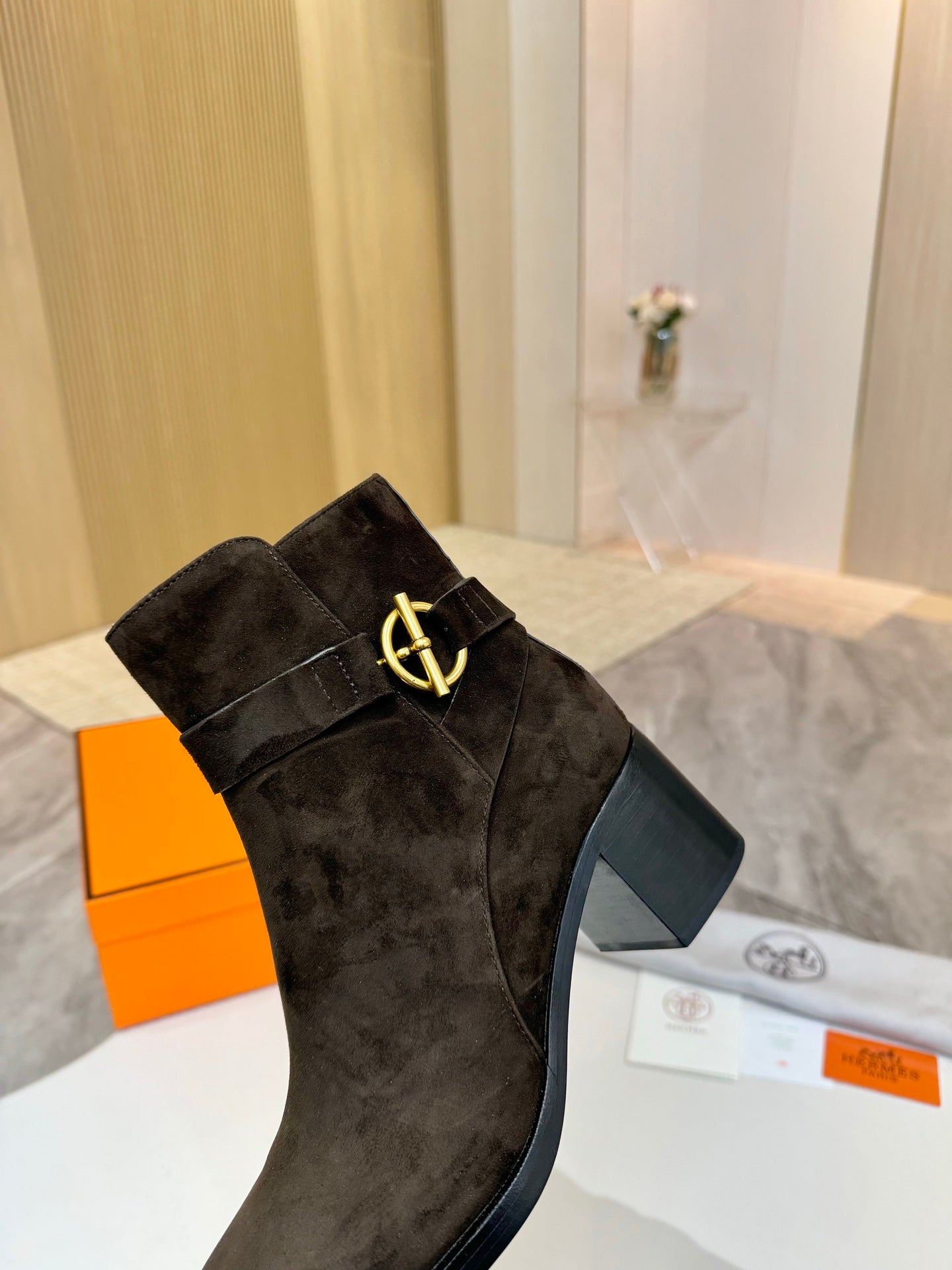 Hermes black suede ankle boot with gold logo buckle and dark block heel