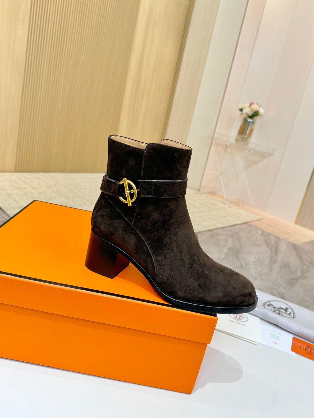 Hermes black suede ankle boots with gold V-style logo buckle and block heel