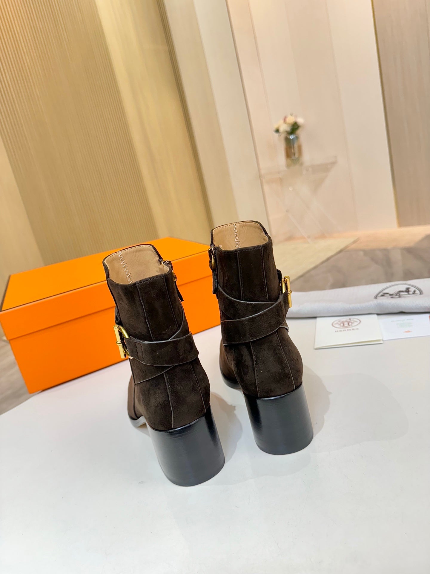 Hermes black suede ankle boots with gold logo buckle and tan interior lining