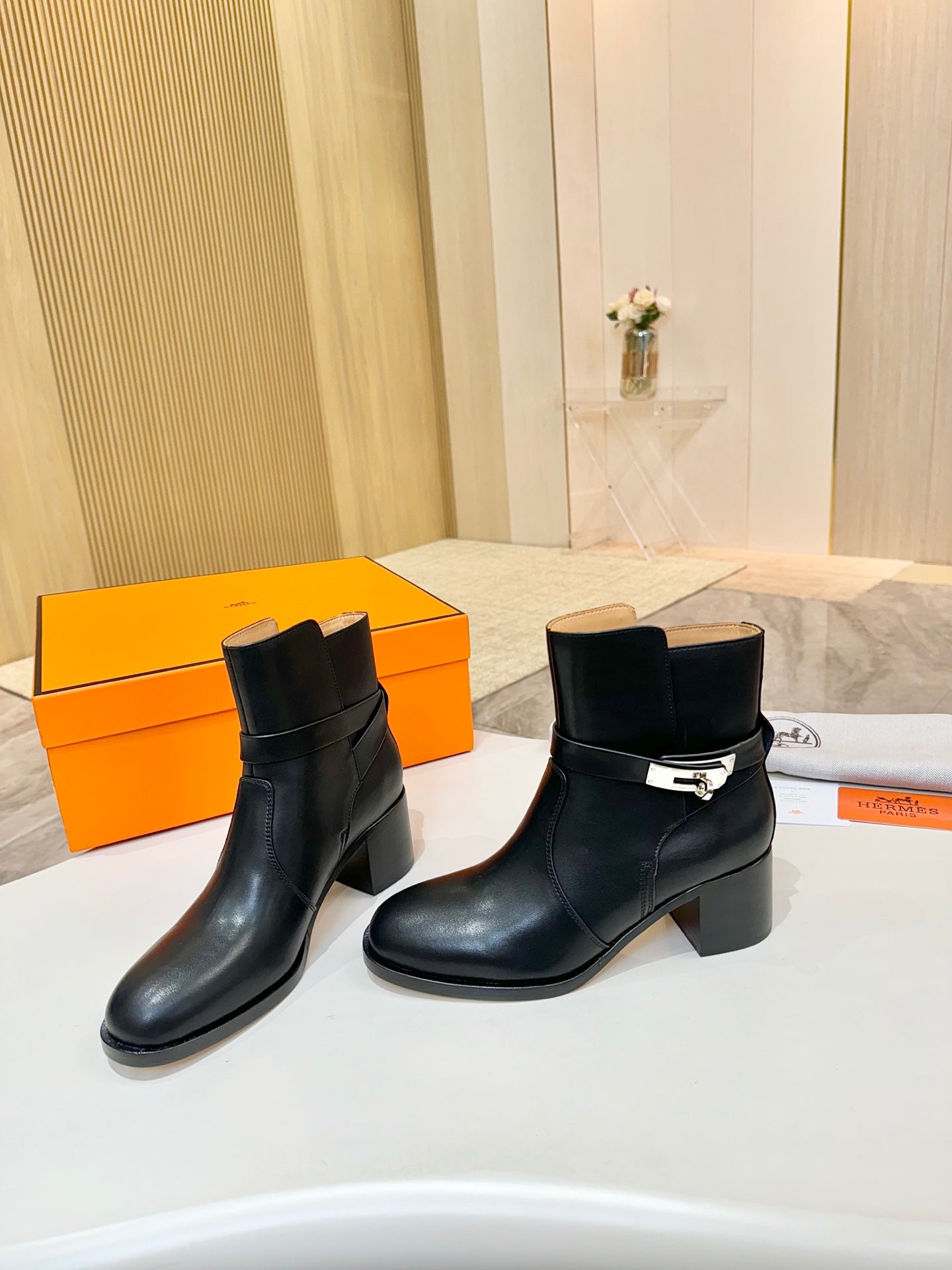 Hermes black leather ankle boots pair with block heel and metal buckle
