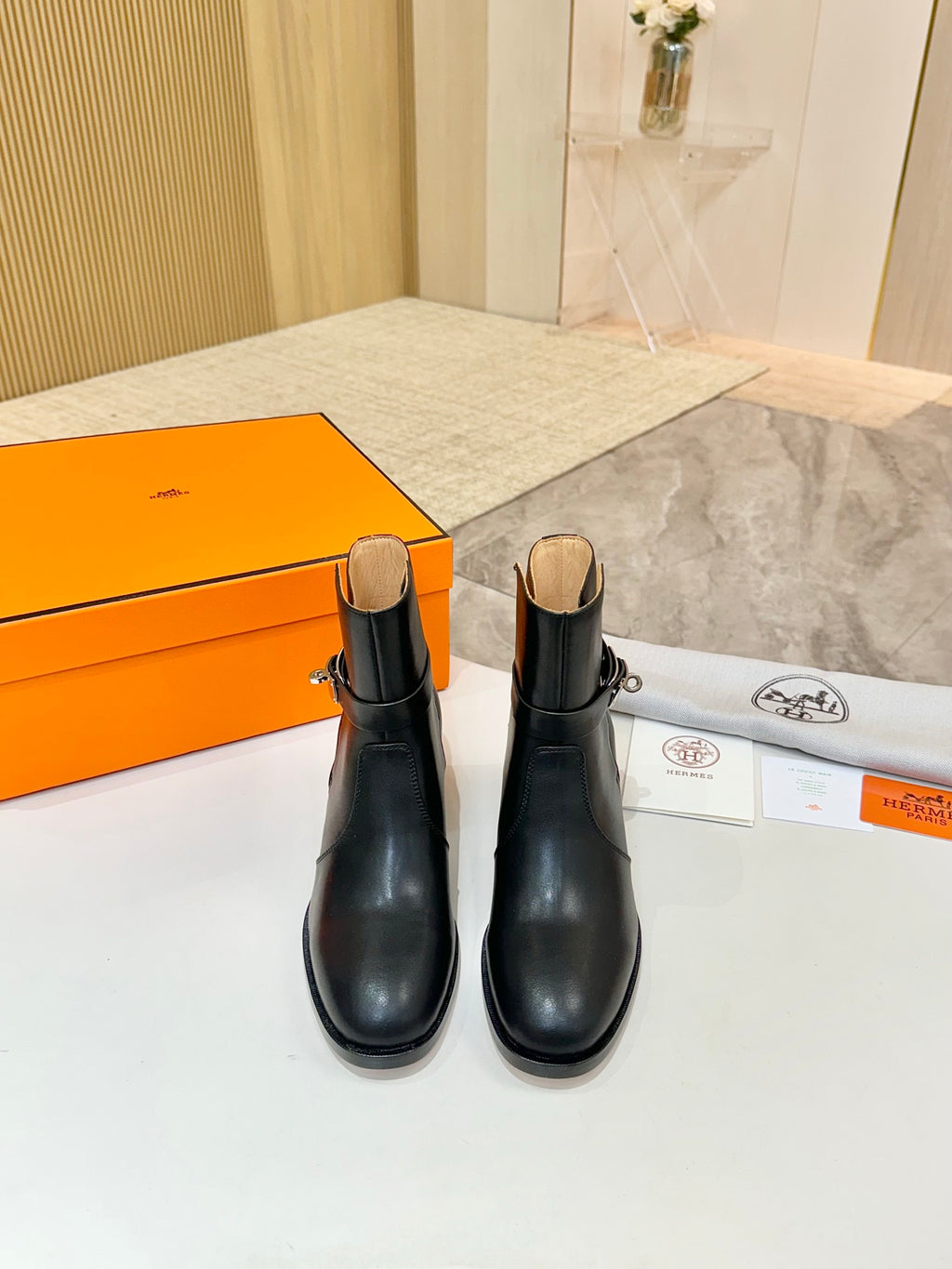 Hermes black leather ankle boots pair view, block heel and ankle pull tab
