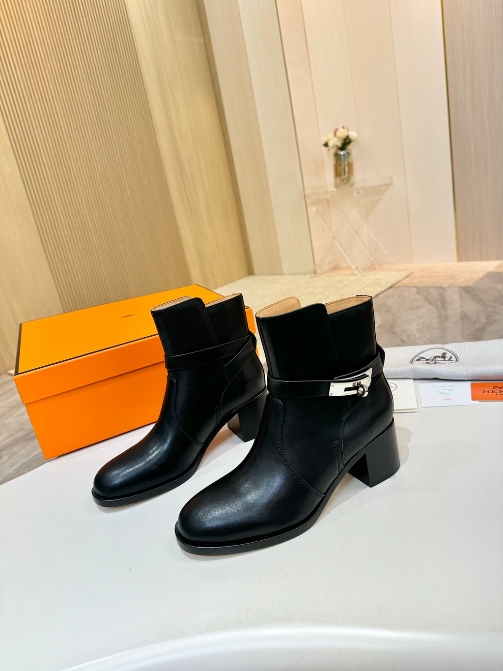 Hermes black leather ankle boots with cuff pull-up and silver buckle detail