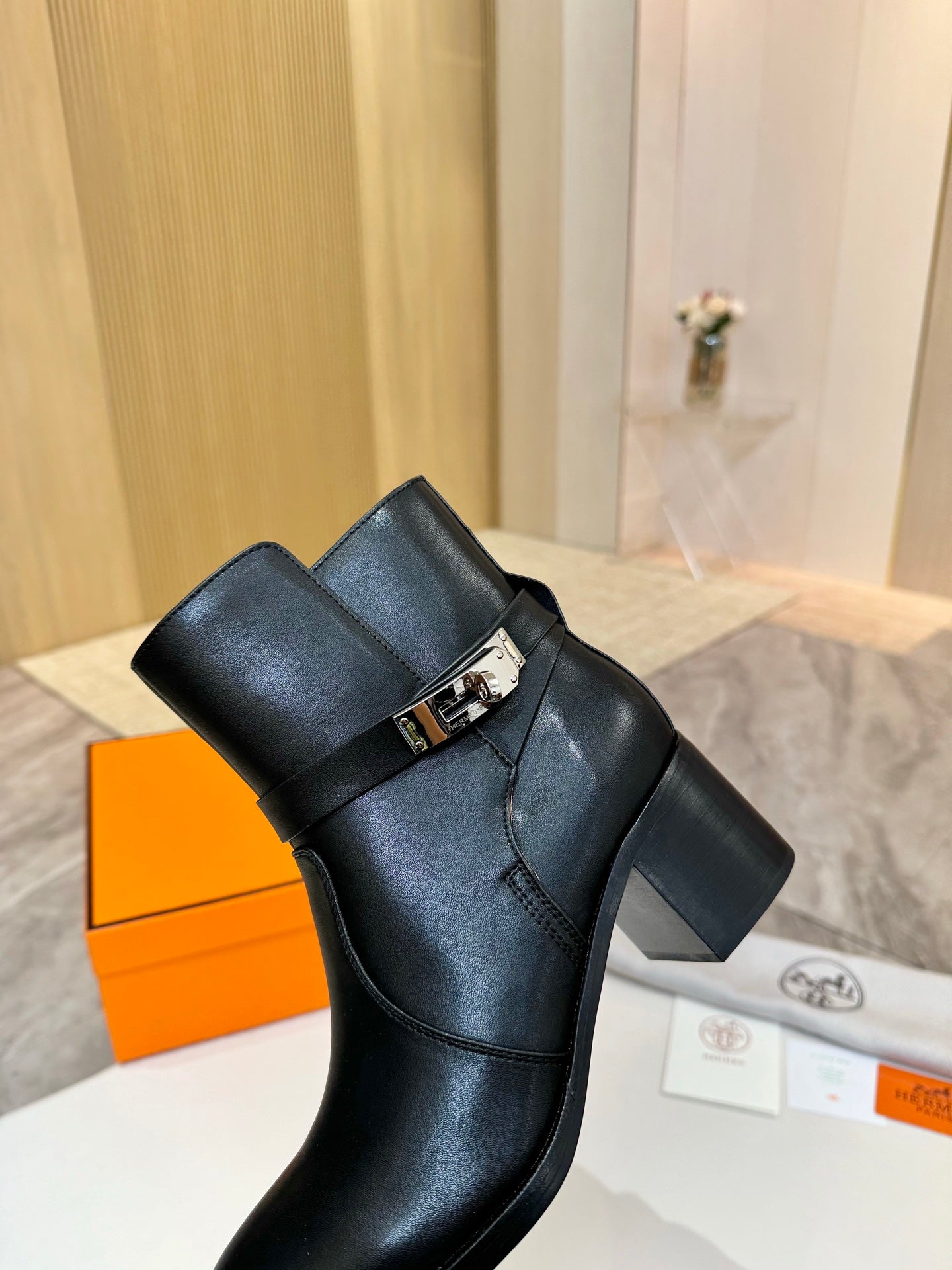 Hermes black leather ankle boots with strap buckle and mid-height block heel