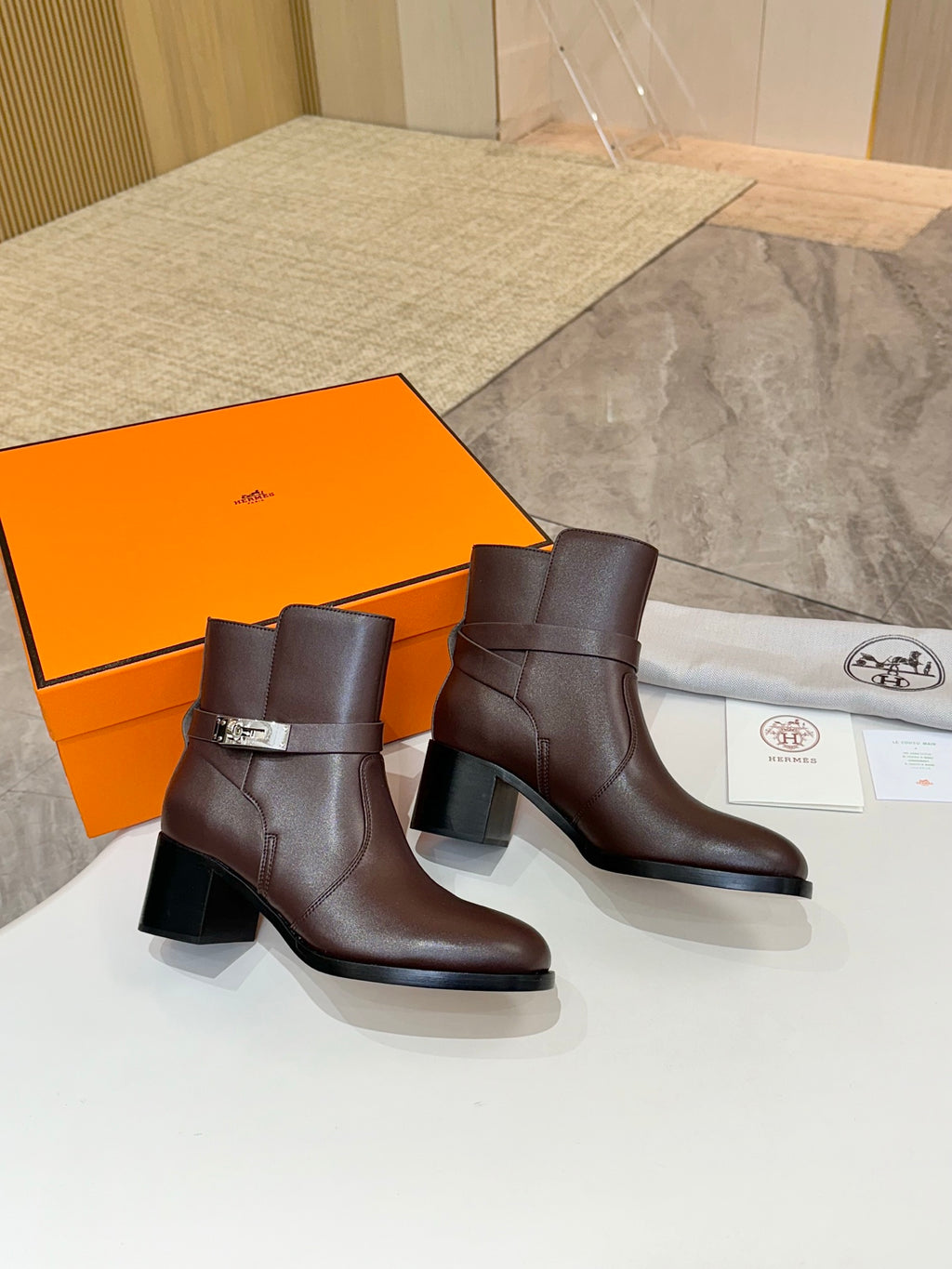 Pair of dark brown leather ankle boots with block heels and buckle details
