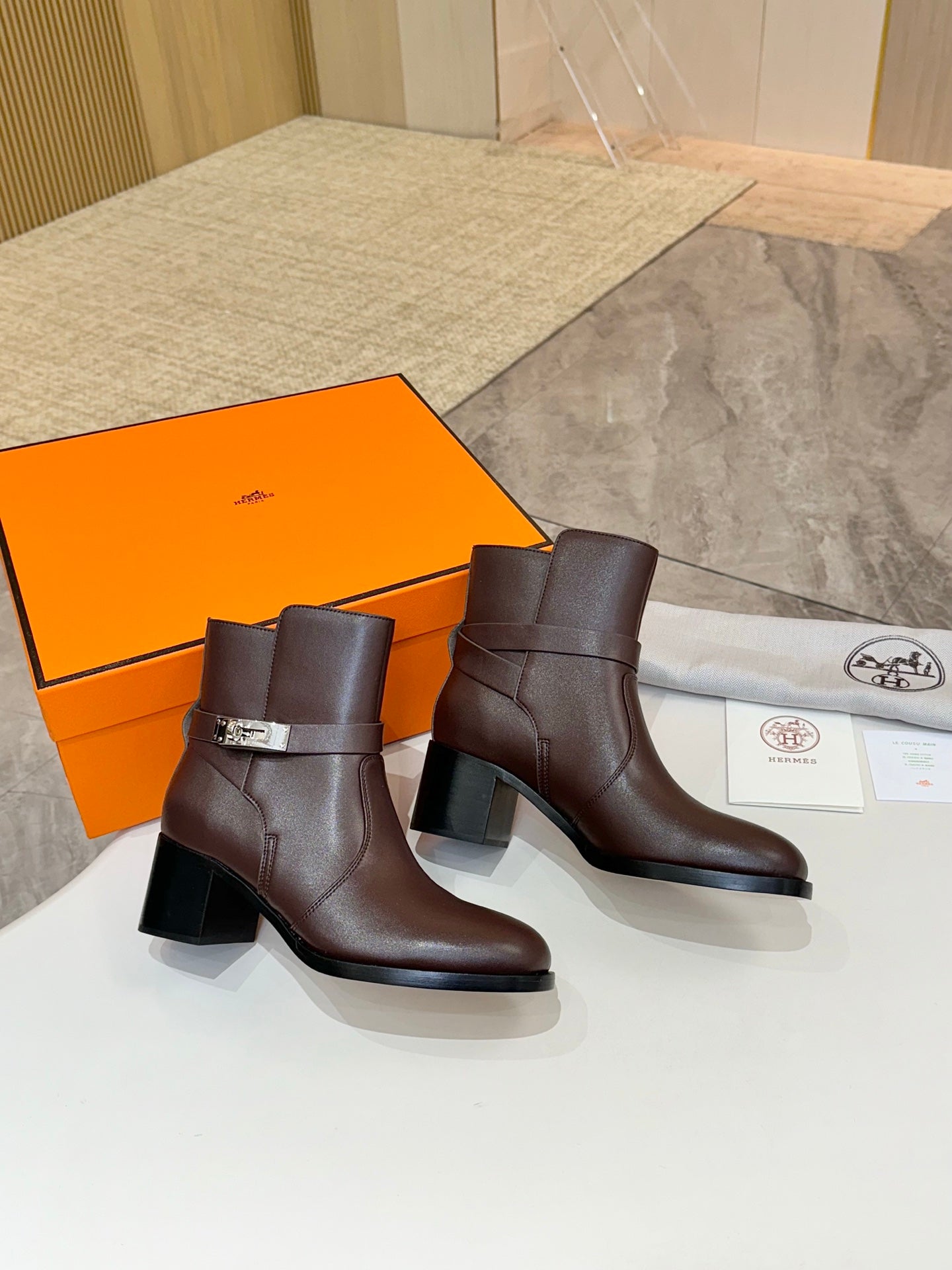 Pair of dark brown leather ankle boots with block heels and buckle details