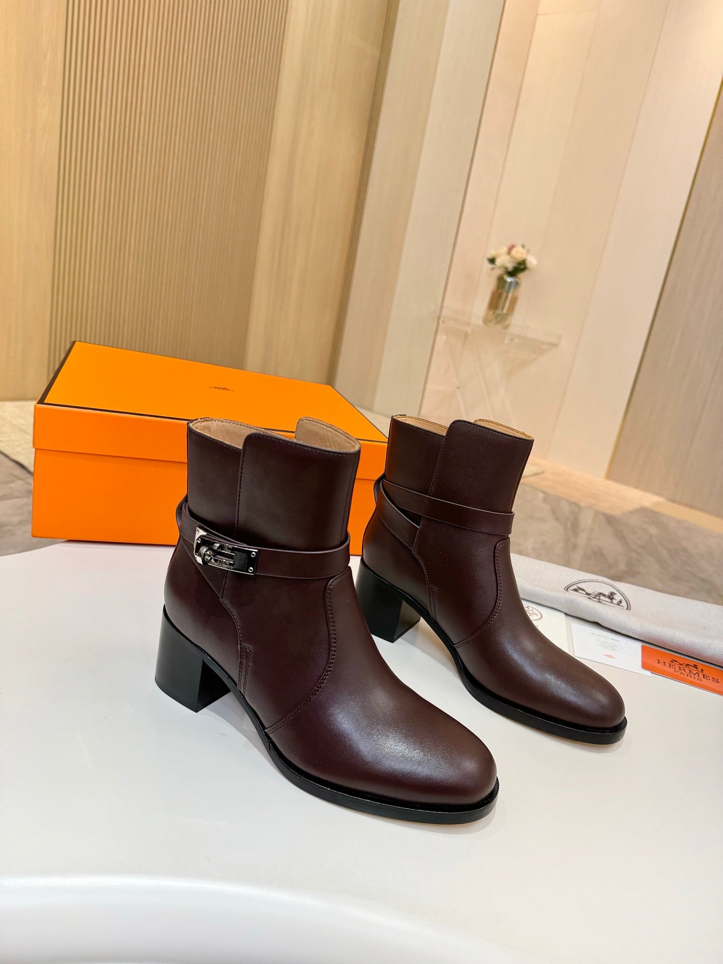 Dark brown leather ankle boots with silver buckle strap and chunky heel