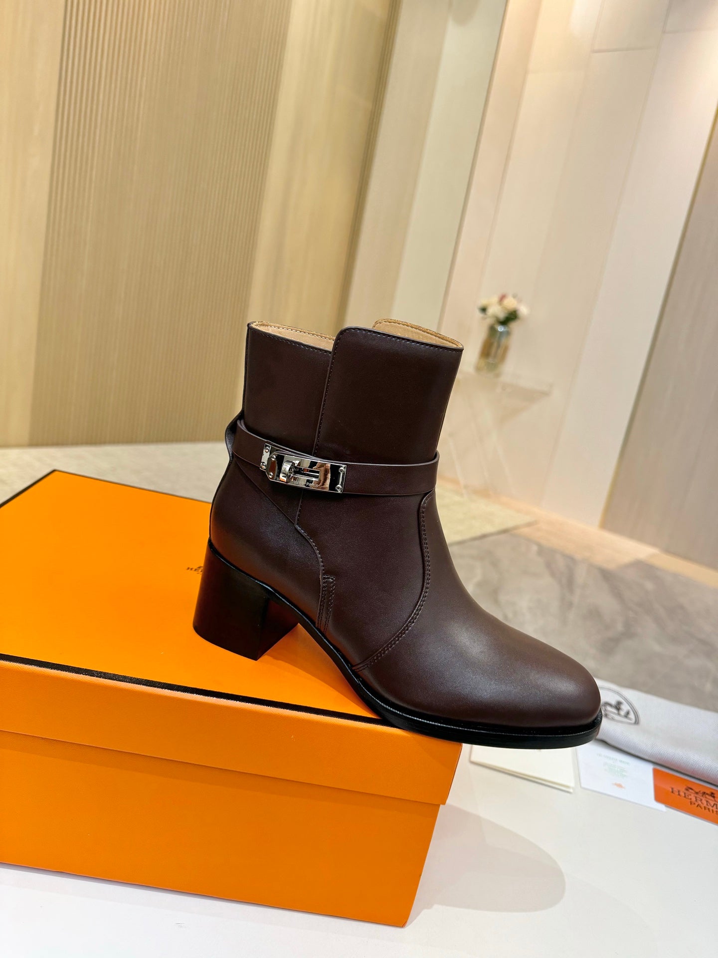 Dark brown leather ankle boots with square buckle strap and block heel