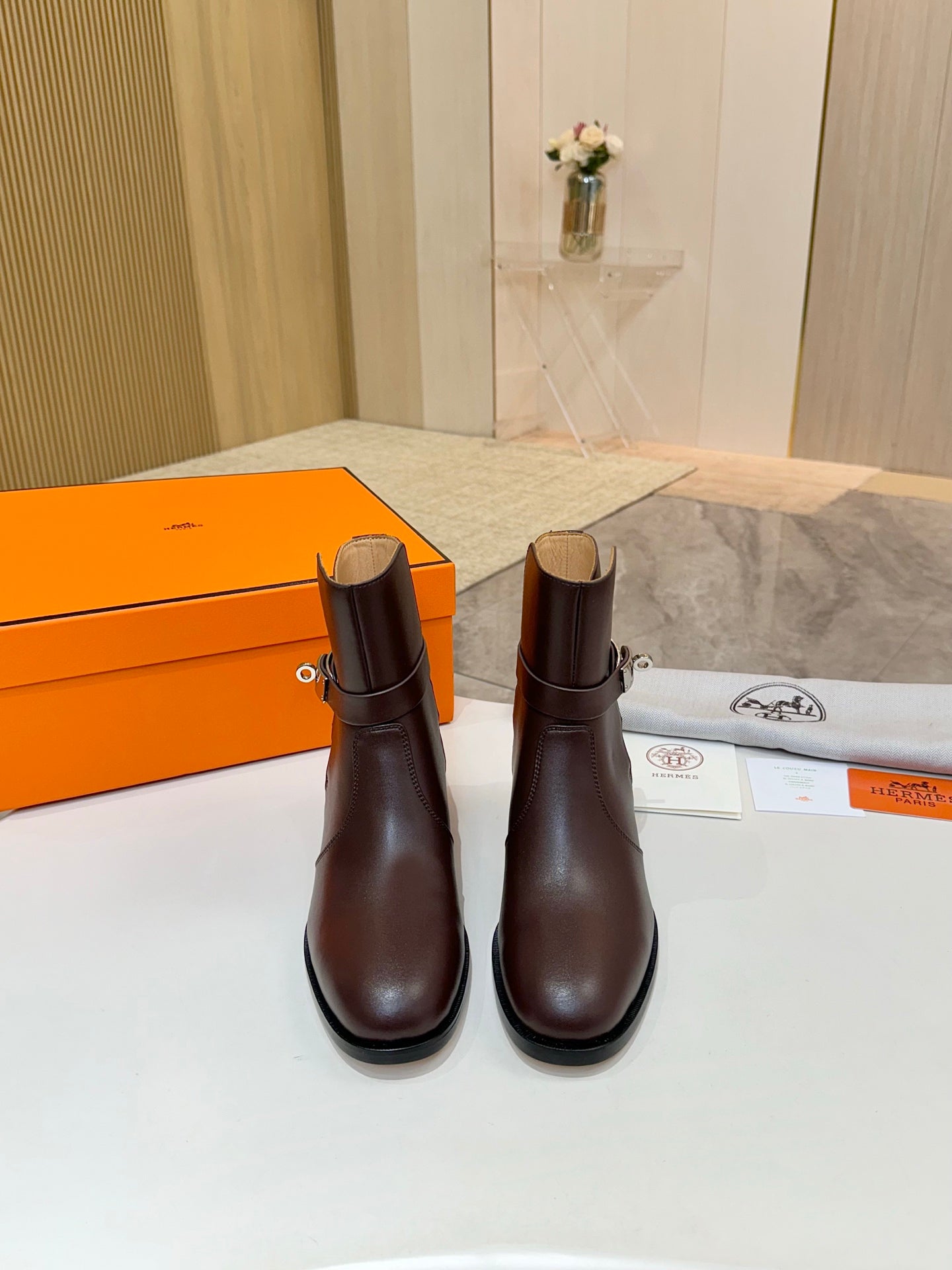 Two dark brown leather ankle boots with rounded toe and stacked block heel
