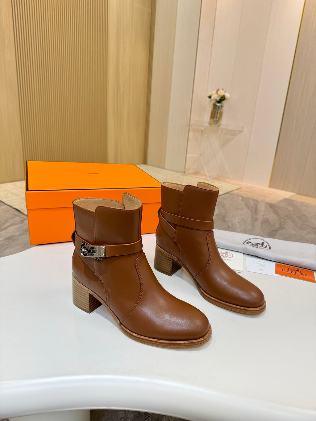 Hermes ladies brown leather ankle boots, angled view with buckle and block heel