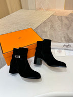Hermes black suede ankle boots, side view with silver buckle detail and block heel