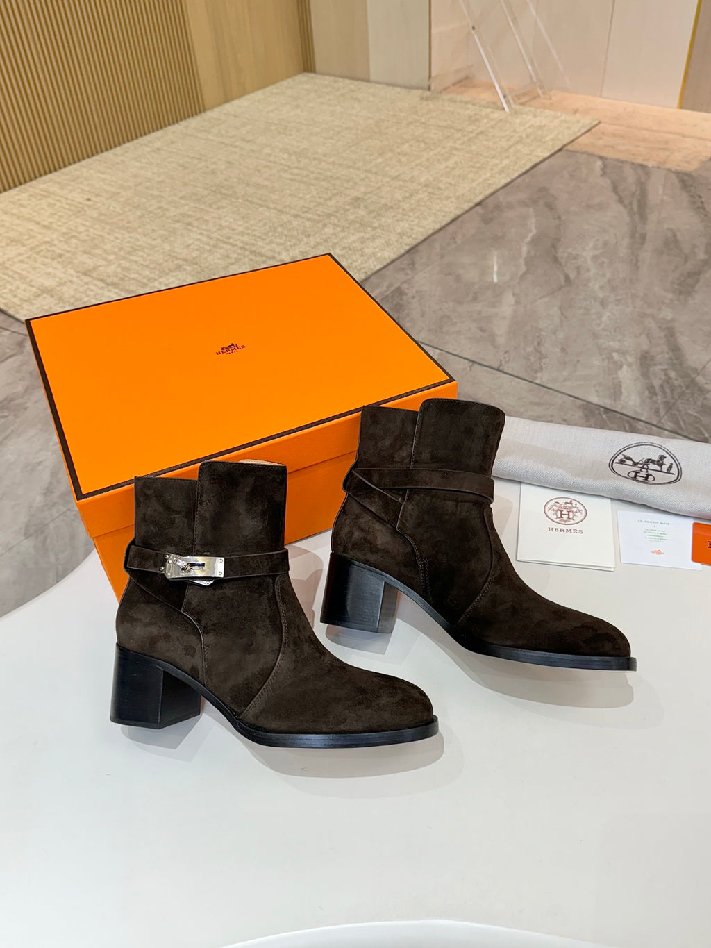 Women’s black suede ankle boots with side buckle strap and mid-height block heel