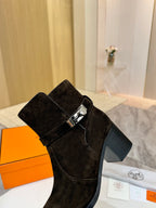 Black suede women’s ankle boot with square buckle strap and block heel