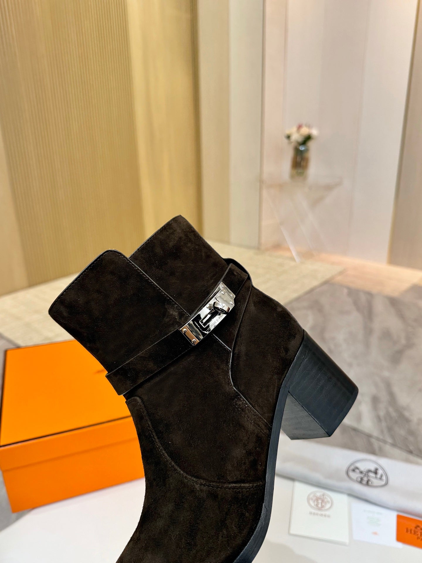 Black suede women’s ankle boot with square buckle strap and block heel