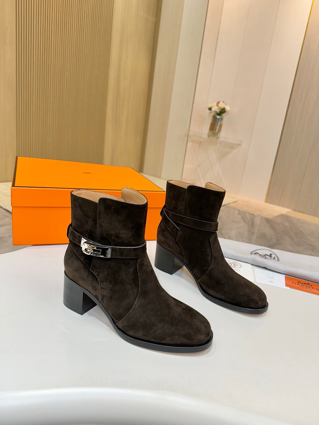 Women’s black suede ankle boots with side buckle detail and block heel