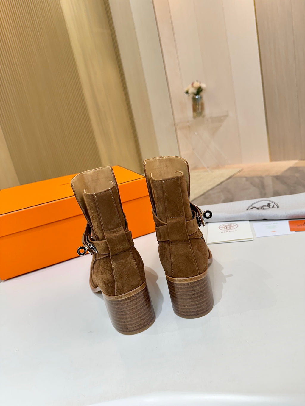 Back view of suede ankle boots with block heel, brown suede and pull tab