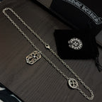 Pair of silver-tone pendant necklaces with shield and cross-shaped charms