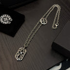 Silver-tone pendant necklace with shield charm and oval clasp on chain