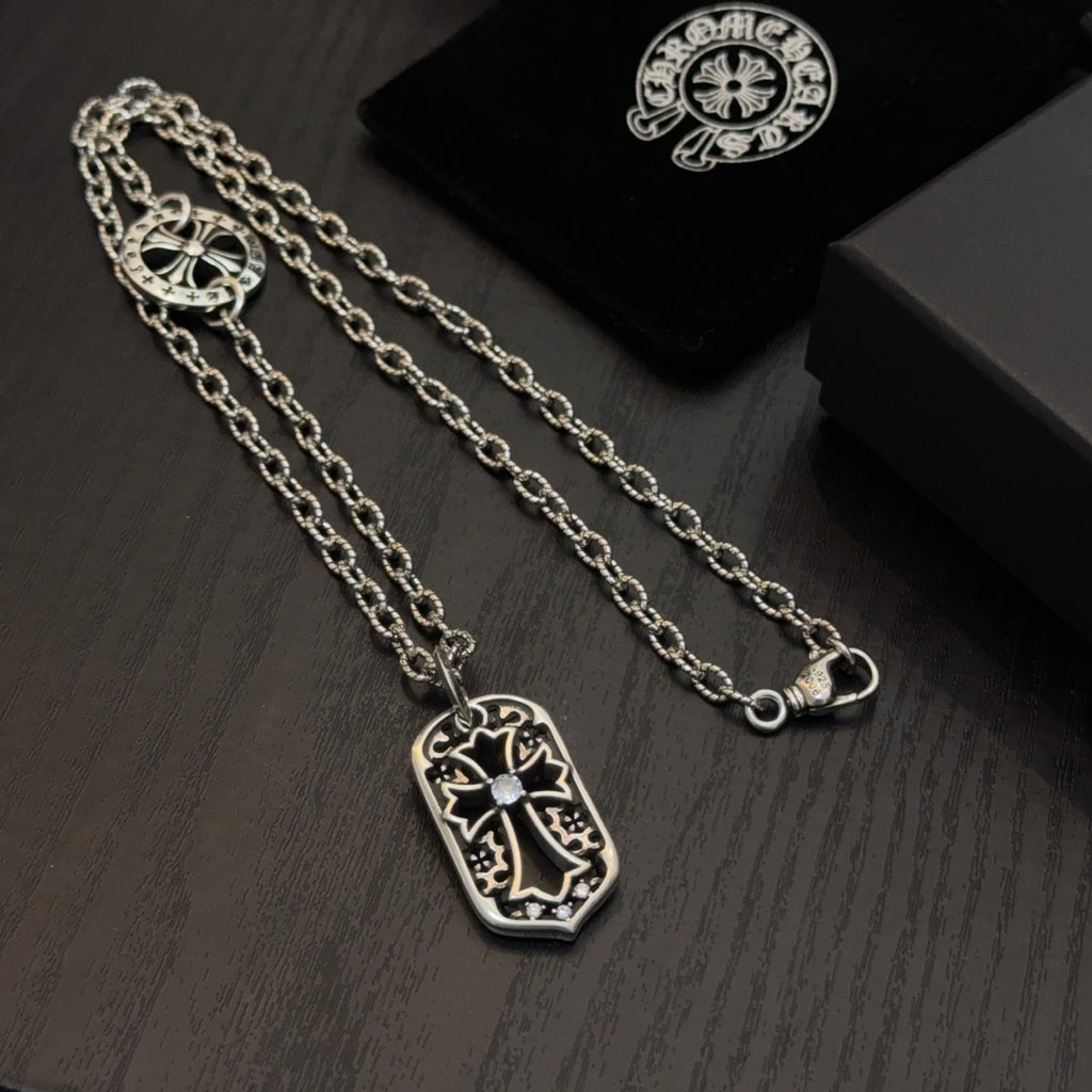 Set of silver-tone pendant necklaces with shield charms and clasp detail