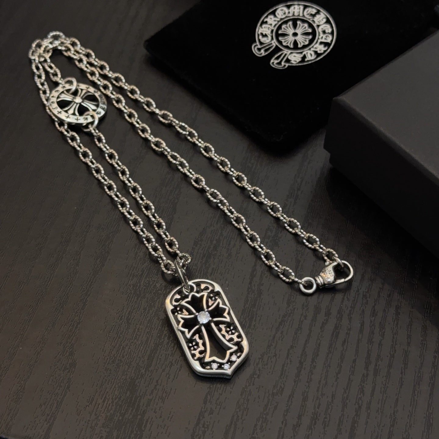 Set of silver-tone pendant necklaces with shield charms and clasp detail