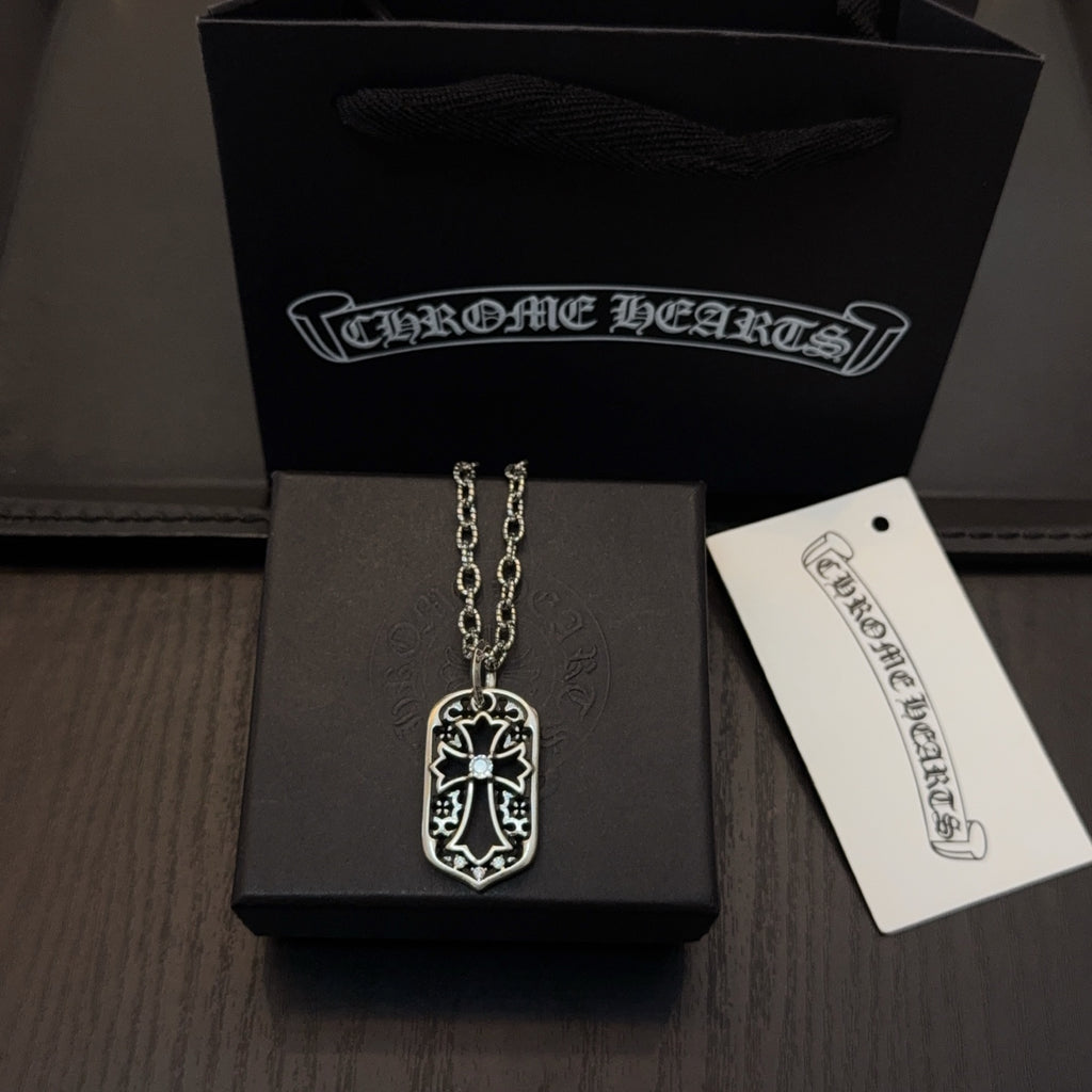 Silver-tone pendant necklace with shield charm on a long chain