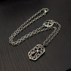 Silver-tone necklace with shield pendant and oval clasp on extended chain
