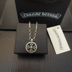 Silver-tone round pendant necklace with teal stones, on black jewelry box.