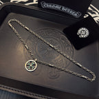 Silver-tone chain necklace with round teal-stone pendant, plus small stud earring.