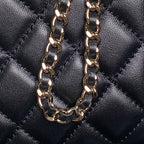 Gold-tone curb chain strap on black quilted mini bag